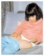 A diabetic child injects herself with insulin. Composed of 51 amino acids, insulin is a small protein used by the body to regulate glucose levels in the blood. [Custom Medical Stock Photo. Reproduced by Permission.]