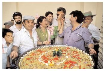 A Spanish celebration featuring paella, a rice and seafood dish served here in a giant paellera. Saffron, a spice from the Muslim countries to the south and east, gives the dish its yellow color. [Photograph by Owen Franken. Corbis. Reproduced by permission.]